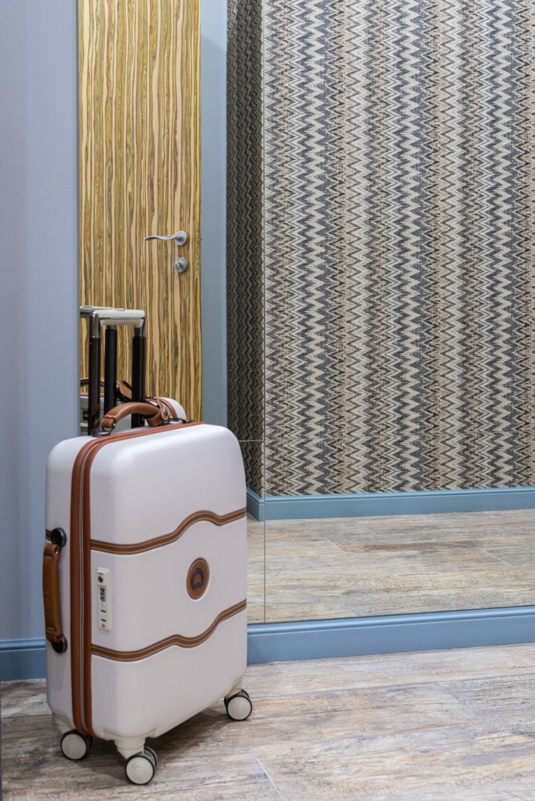A suitcase in a room entrance. Stock photography, not a representation of Japanese room sizes.